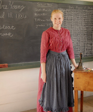 The female teacher at a one room schoolhouse.