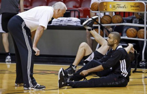 Coach Gregg Popovich (L) talks with guard Tony Parker during a team ...