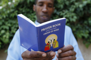 Kenyan Reading a Prayer Book Photographic Print
