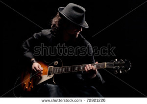 stock-photo-guitarist-in-black-hat-playing-guitar-72921226.jpg