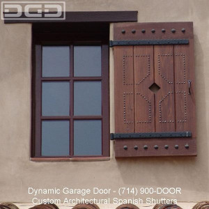 ... wooden shutters with rustic iron hardware by Dynamic Garage Door of