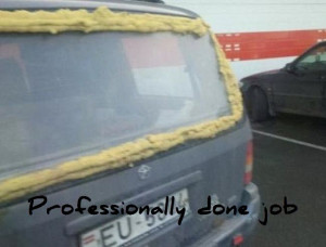 Is a picture of a back window of a van. That window has foam sticking ...