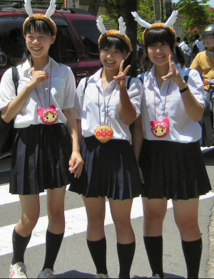 ... Schoolgirls in school uniform and stupid hats - trying to look cool