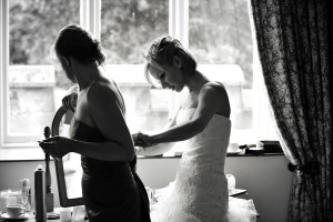 Bride And Bridesmaid Getting Ready For Wedding At St Audries Park