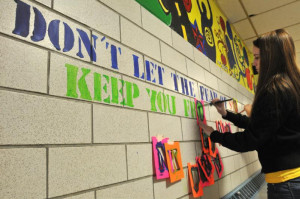 Easthampton High School sophomore Marisa Dineen paints the words 