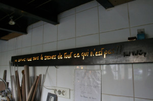 on the back wall of emmanuelle's studio is a quote
