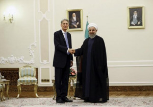 Britain's Foreign Secretary Philip Hammond (L) shakes hands with Iran ...