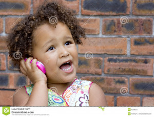 Stock Image: Young black baby girl on a toy cell phone