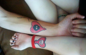 Couple tattoo, love infinity with the date in Roman numberals on wrist