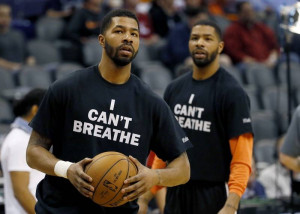 , and his brother, Marcus Morris, warm up prior to an NBA basketball ...