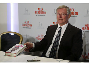 Former Manchester United manager Sir Alex Ferguson poses with his book ...