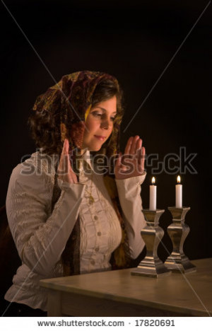 Jewish woman regards lit sabbath candles; low key; unsharpened - stock ...