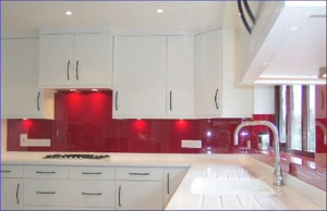 Sleek and Shiny Glass Red Backsplash in this Contemporary Kitchen