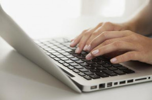 Woman's hands typing on laptop computer - PhotoAlto/Antoine Arraou ...