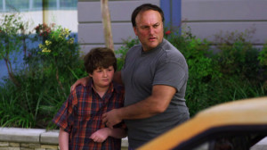 Man Holds Son Looks Yellow Car