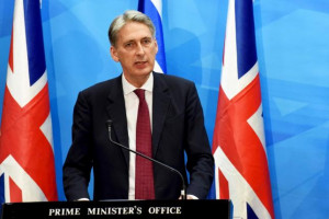 British Foreign Secretary Philip Hammond delivers a joint statement to ...