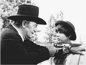 Rooster Cogburn shows Mattie Ross how to fire a pistol. John Wayne's