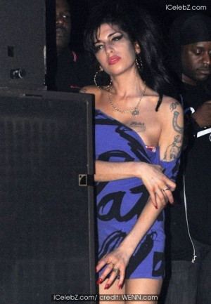 Amy Winehouse looks on as Nas and Damian Marley perform at Hammersmith ...