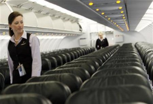 Frontier Airlines flight attendant Cheryl Jacquot checks seats for ...