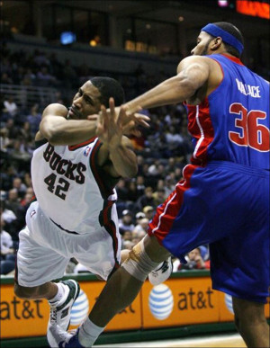 Milwaukee Bucks guard Charlie Bell goes flying after being fouled by ...
