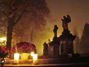 All Saints' Day at a cemetery in Sanok - flowers and lit candles are ...