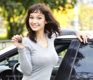 Pretty girl showing the car key - Stock Image