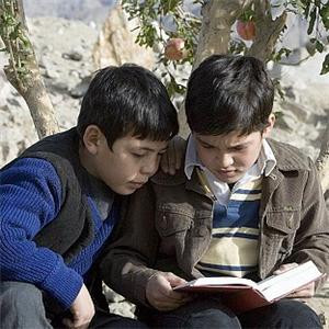 Amir and Hassan sitting under the Pomegranate Tree