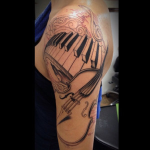 guitar-and-piano-keys-left-half-sleeve-tattoo.jpg
