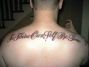 Nice Quote Tattoo On Man Upperback