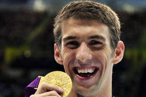 Michael Phelps of the U.S. celebrates with his gold medal at the men's ...