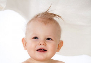 the little baby boy sports a modest spiky hairdo created for a cute ...