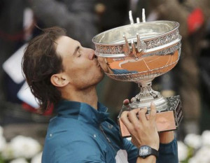 Rafael Nadal of Spain kisses the trophy after defeating compatriot ...