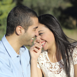 Arab casual couple flirting laughing happy in a park