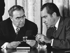 ... Party Chief Leonid Brezhnev exchange pens after signing agreement