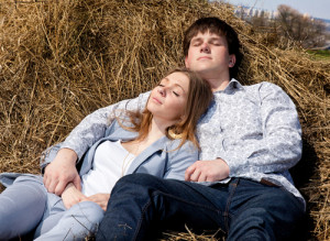 Falling Asleep In Your Arms - Couple lying in the hay