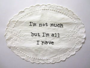 quote by Philip K. Dick embroidered onto doily from charity shop.