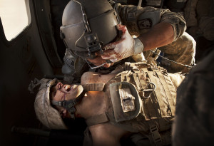 flight medic SGT Jaime Adame, top, cares for seriously wounded Marine ...