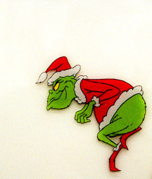 The Dr. Seuss character Grinch creeps toward a Christmas tree in this ...