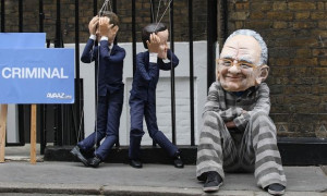 protester wearing a Rupert Murdoch mask demonstrates with David ...