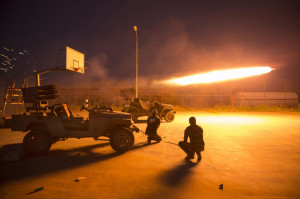 Shi’ite fighters fire a rocket during clashes with Islamic State ...
