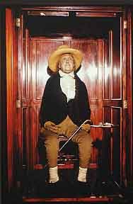 Jeremy Bentham sitting in the UCL cloisters