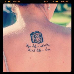 Small Camera And Quote Tattoo On Upper Back