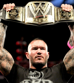 Randy Orton holding his gold
