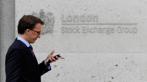man walks past the London Stock Exchange in central London