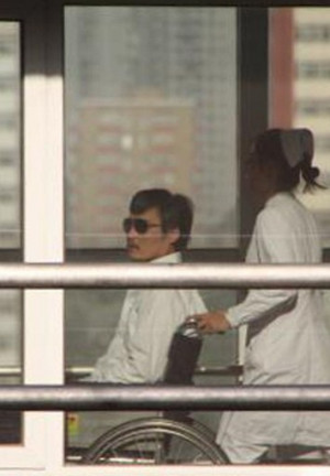 Chinese activist activist Chen Guangcheng (L) is seen in a wheelchair ...