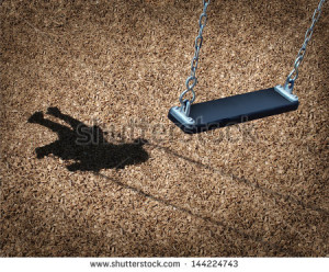 Missing child concept with an empty playground swing and the shadow of ...