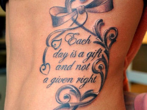 tattoo with note and nice quote - best ribbon tattoo ideas