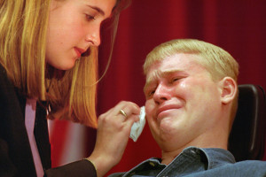 Travis Roy cries and has his tears wiped away by his then girlfriend ...