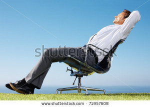 ... of a young businessman sitting relaxed on chair against sky 71957608