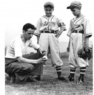 Carl E. Stotz, holding a baseball, posing with Harold 